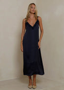 Woman wearing a navy dress  on a white background