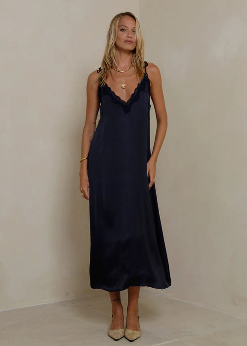 Woman wearing a navy dress  on a white background