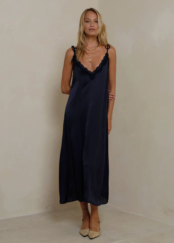 Woman wearing a navy dress  on a white background