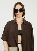 Woman wearing black sunglasses on whit background