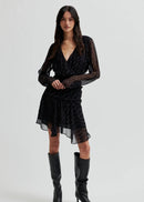 Woman wearing a black dress on a white background