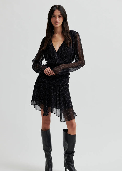 Woman wearing a black dress on a white background
