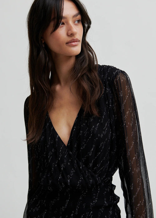 Woman wearing a black dress on a white background
