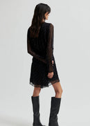 Woman wearing a black dress on a white background