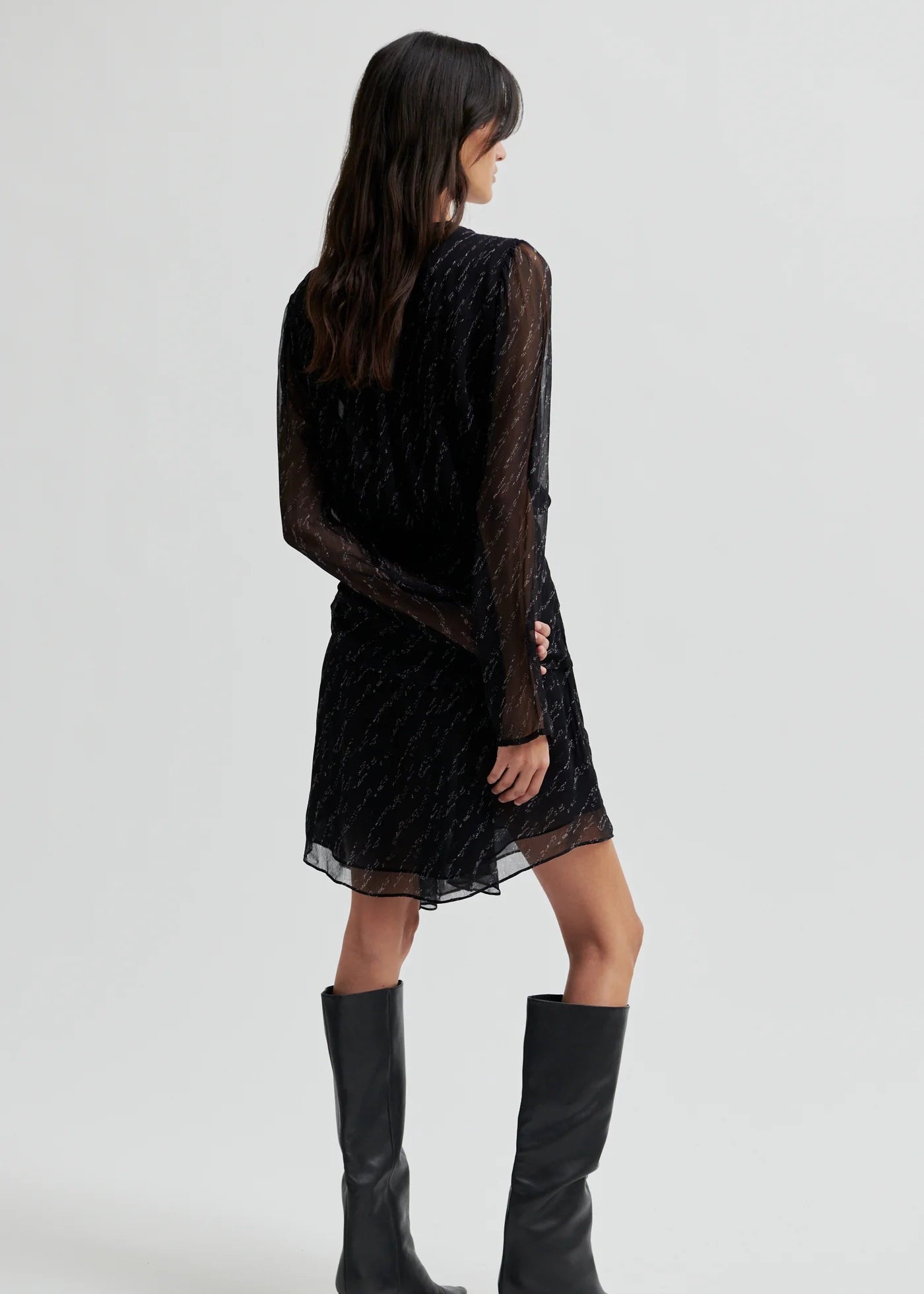 Woman wearing a black dress on a white background