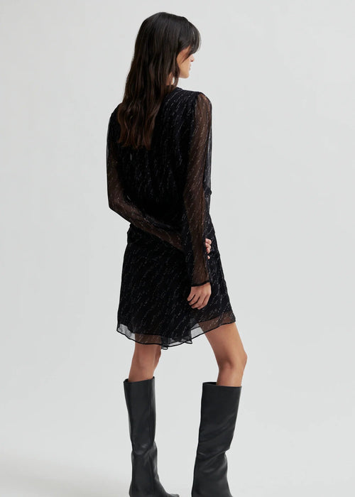 Woman wearing a black dress on a white background