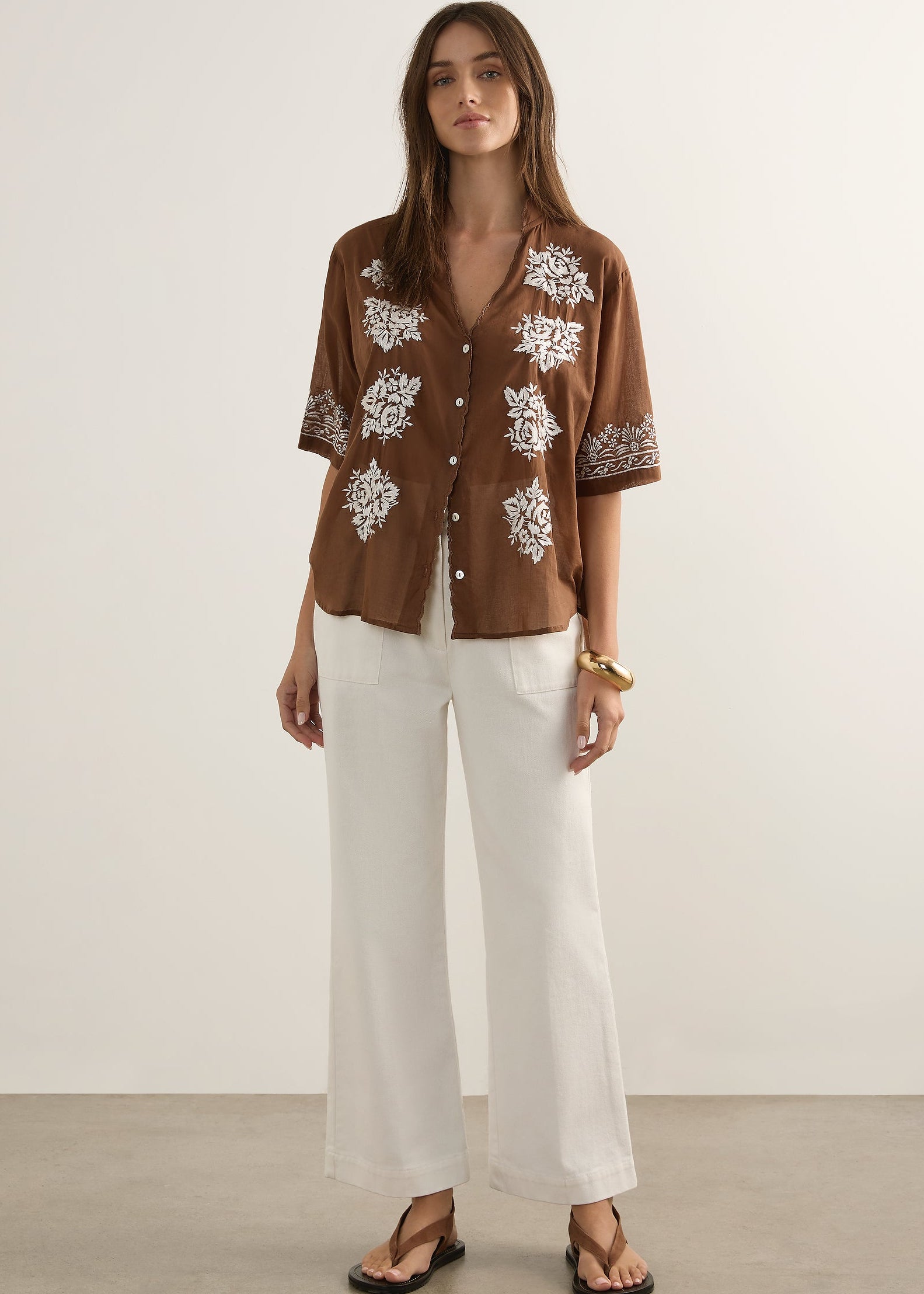 Woman wearing brown top on white background