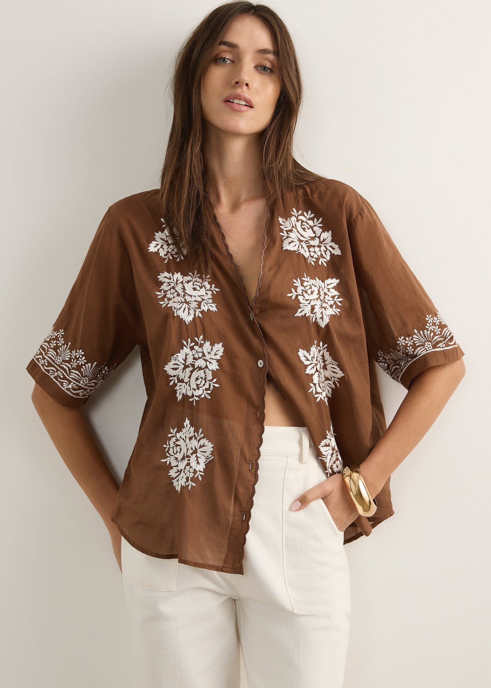 Woman wearing brown top on white background