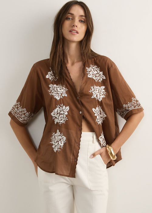 Woman wearing brown top on white background