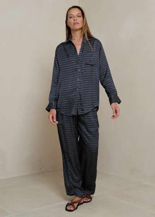 Woman wearing a retro print shirt on grey background