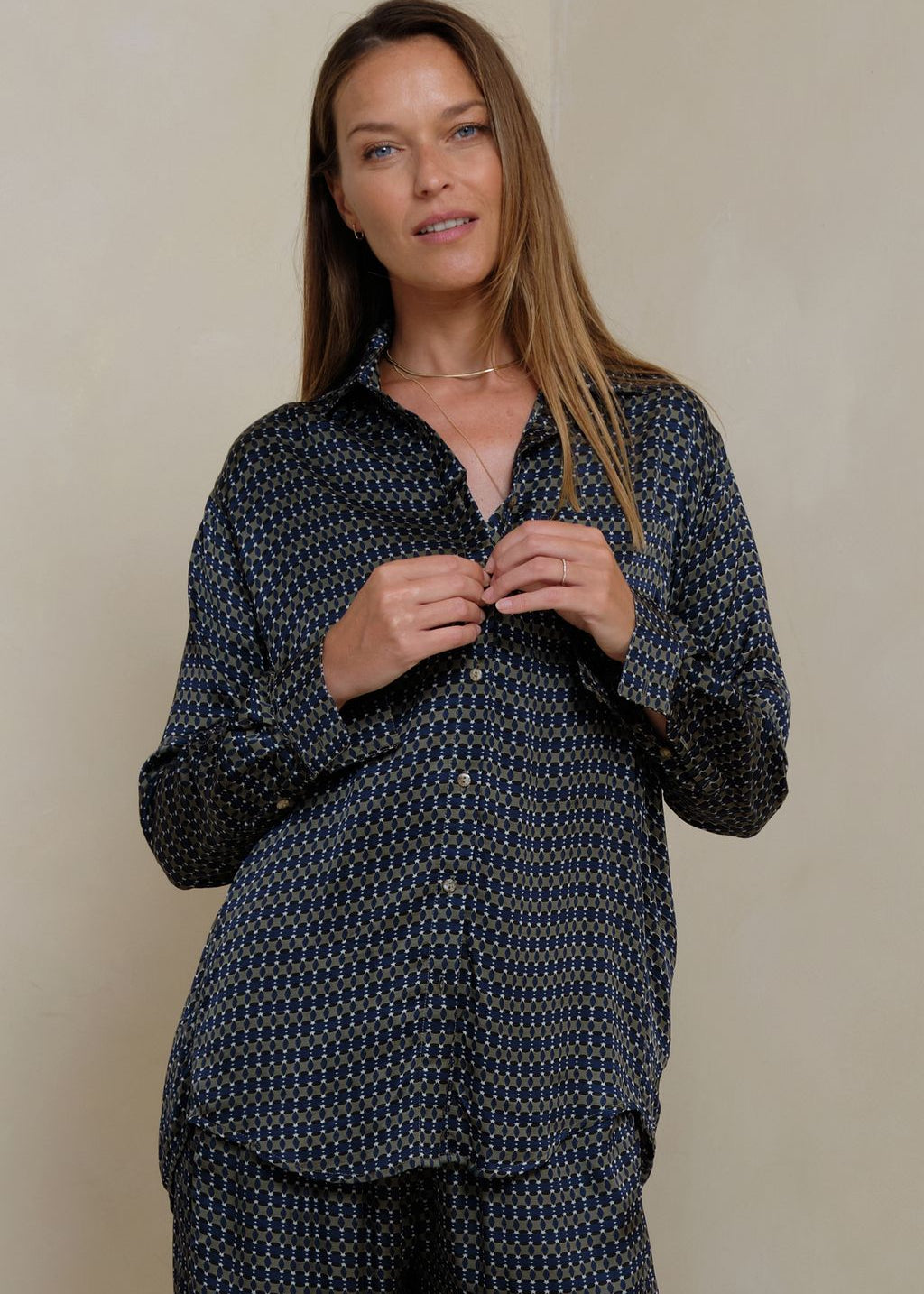 Woman wearing a retro print shirt on grey background