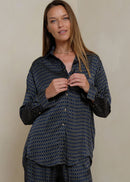 Woman wearing a retro print shirt on grey background