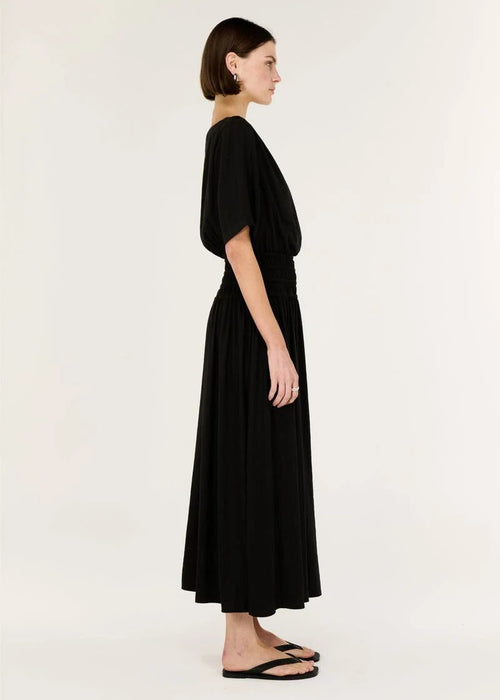 Woman wearing a black dress on a white background