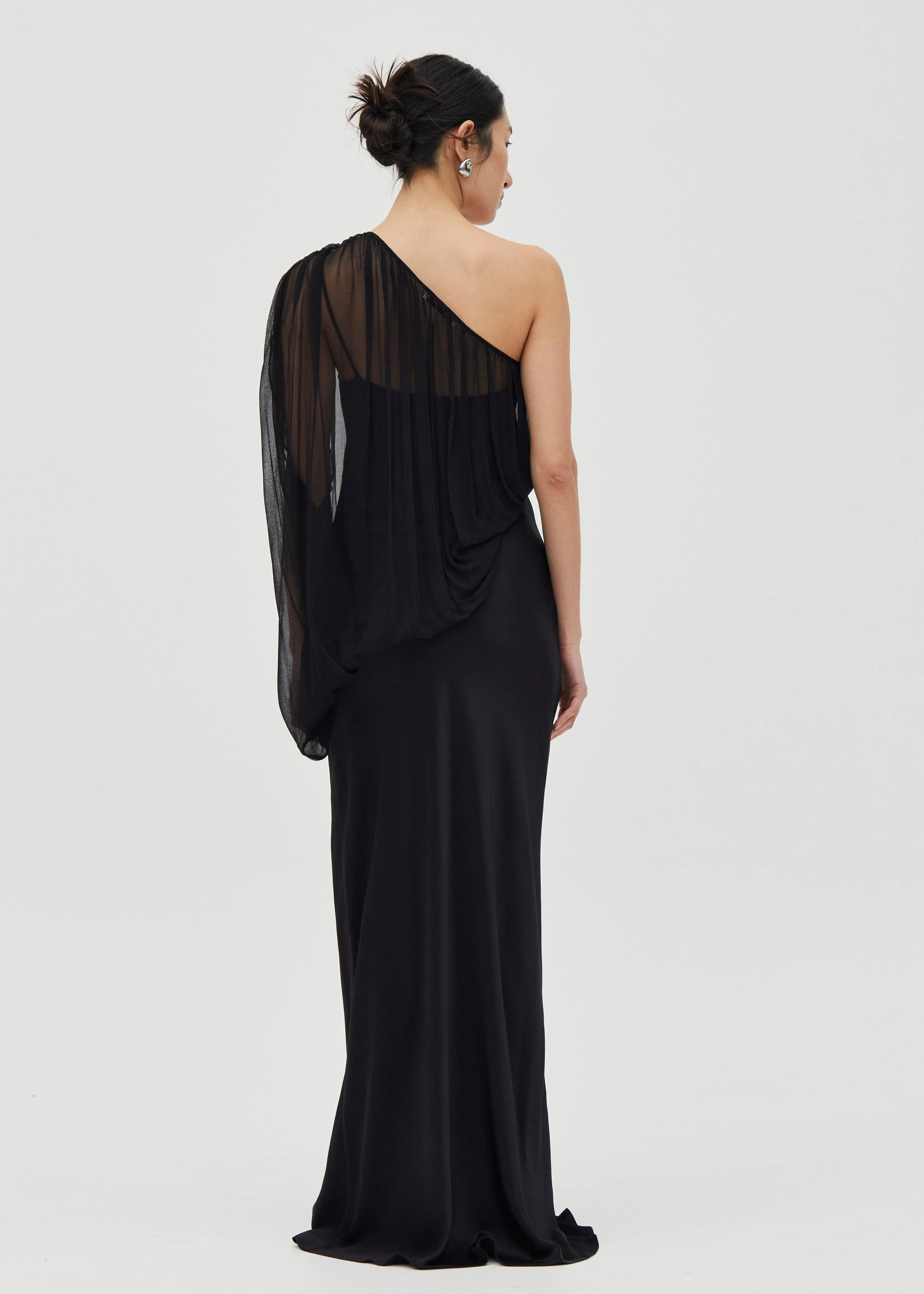 Black one-shoulder evening gown on a white background