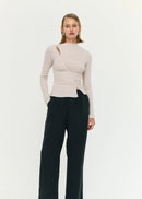 Woman wearing a beige top on white background