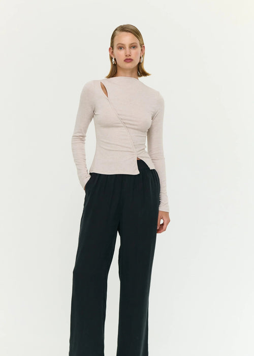 Woman wearing a beige top on white background