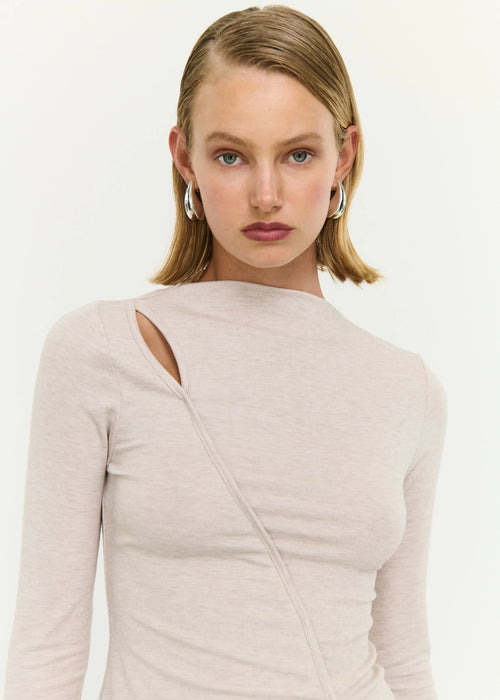Woman wearing a beige top on white background
