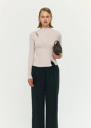 Woman wearing a beige top on white background