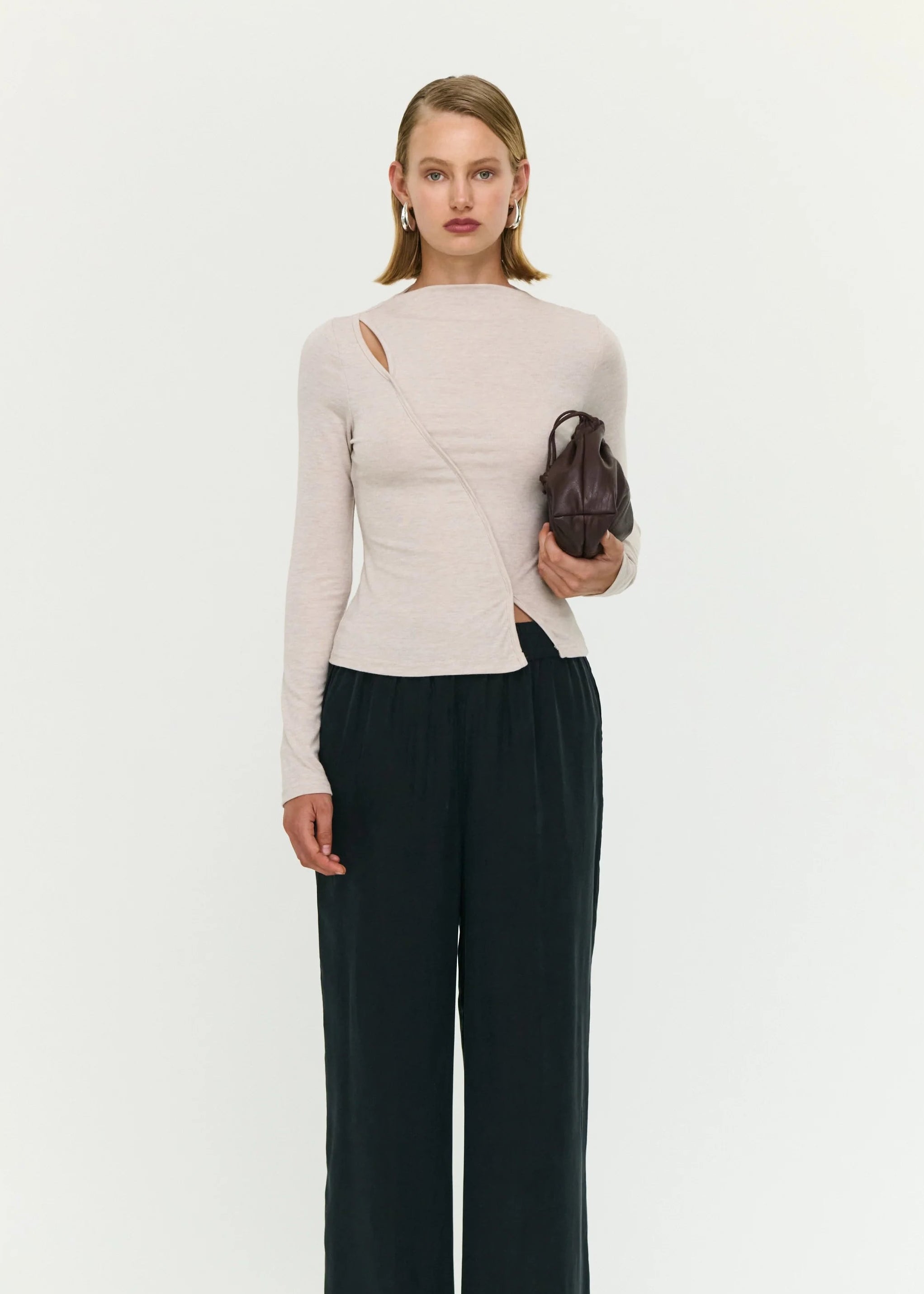 Woman wearing a beige top on white background