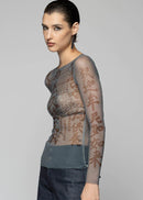 Woman wearing sheer top on light background