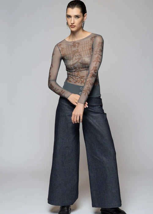 Woman wearing sheer top on light background