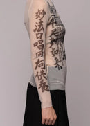Woman wearing sheer top with dragon image on light background