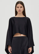 Woman wearing a black outfit on a white background