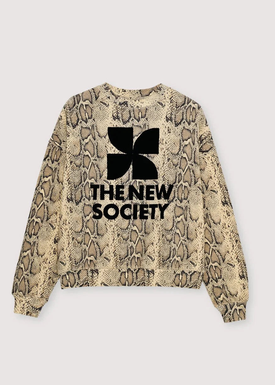 A long-sleeve crewneck sweatshirt featuring a beige and brown snakeskin pattern with a black graphic logo and the text 'THE NEW SOCIETY' printed on the front, set against a light grey background.