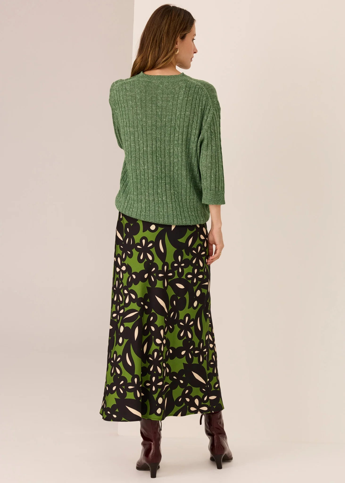 Woman in green sweater with a white background