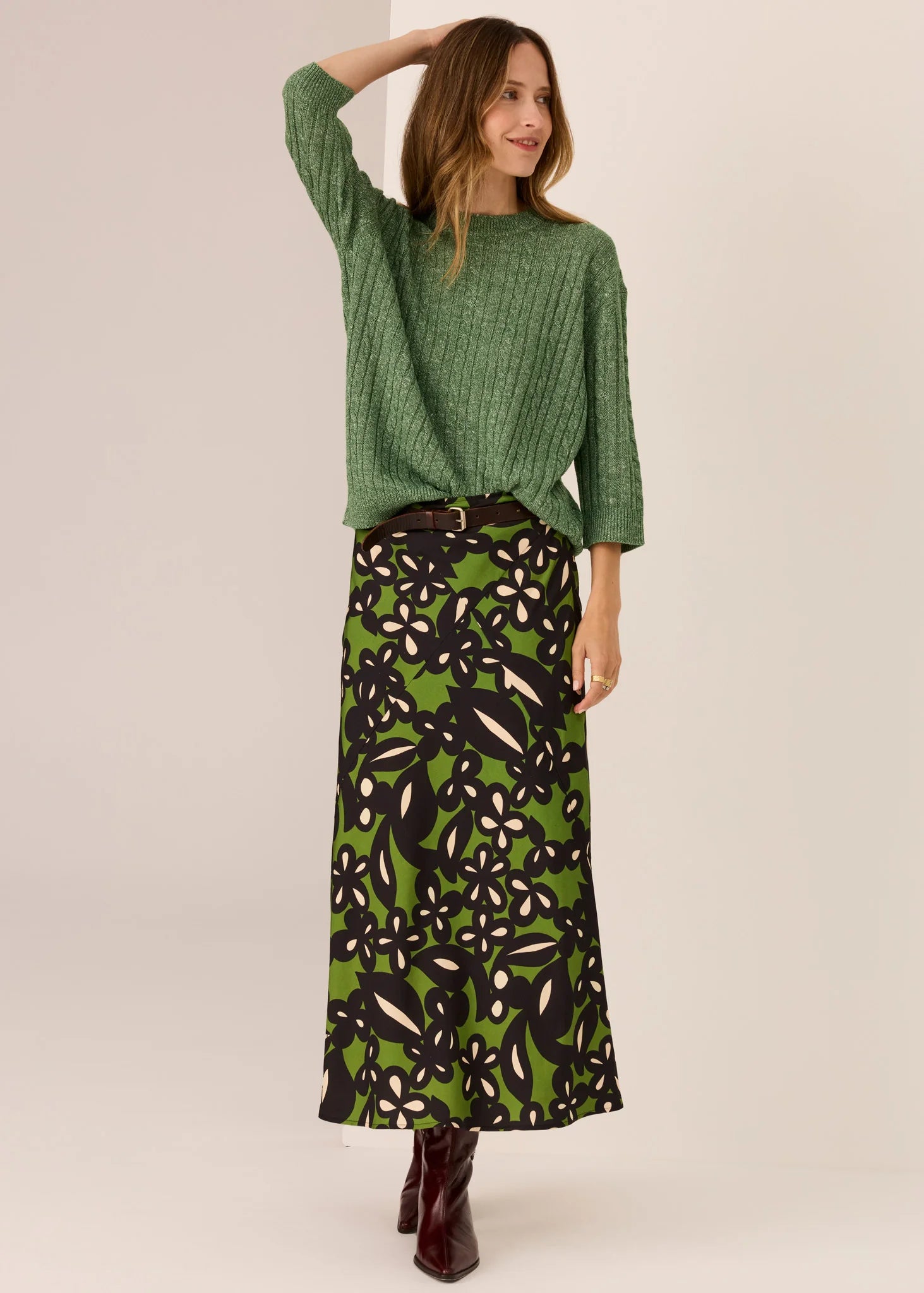 Woman in green sweater with a white background