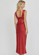 Woman wearing a red lace dress on a white background