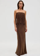 Woman wearing a brown strapless dress with lace detailing on a white background