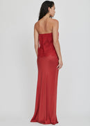 Woman wearing a red strapless dress on a white background