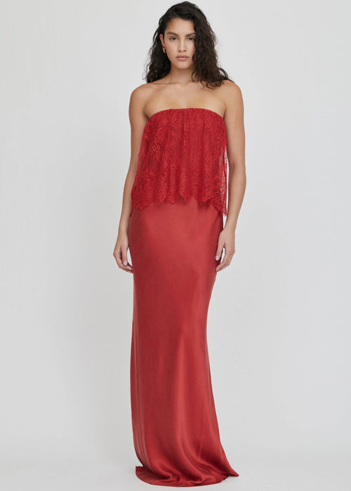 Woman wearing a red strapless dress on a white background