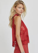 Woman wearing a red lace top on a white background