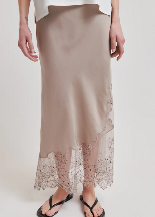 Beige satin skirt with lace hem on a white background